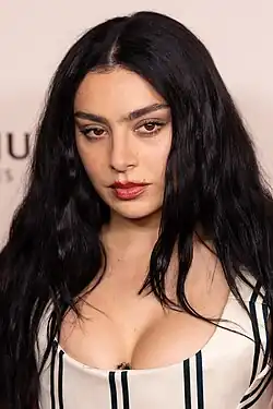 Portrait of Charli XCX, a young woman with long, dark hair