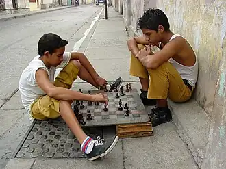 Boys playing chess on a street in Santiago de Cuba, Cuba