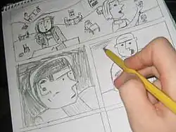 A hand pencils details on a page already largely filled with panels of a comic