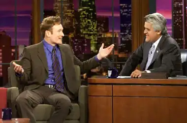 Late night talk show host Conan O'Brien is being interviewed by fellow host Jay Leno