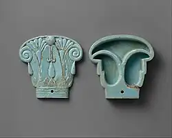 Cosmetic box in the shape of an Egyptian composite capital, its cap being in the left side; 664–300 BC; glassy faience; 8.5 cm × 9 cm (3.3 in × 3.5 in); Metropolitan Museum of Art