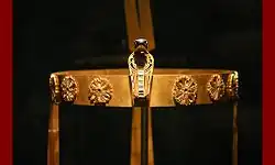 A gold band with rosettes and an elaborately carved uraeus