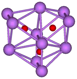 The stick and ball diagram shows three regular octahedra, which are connected to the next one by one surface and the last one shares one surface with the first. All three have one edge in common. All eleven vertices are purple spheres representing caesium, and at the center of each octahedron is a small red sphere representing oxygen.