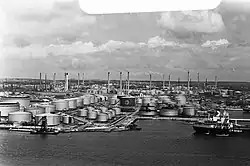 Refinery with several tanks and a bay in the foreground