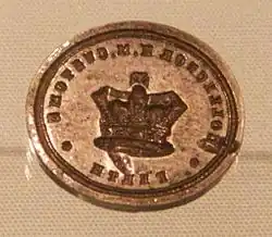 Oval seal with reversed customs notice and royal warrant