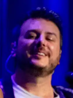 Nigro glancing downwards and smiling