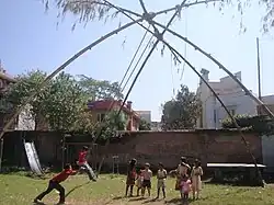 Children standing in a queue for the swing