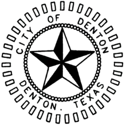 A 3D black and white star. The words "City of Denton Denton, Texas" encircle the star.