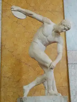 A discus thrower performs an isometric press by applying downward pressure onto his bent right leg. This allows the throw to be performed more powerfully.