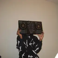 A woman holding a DJ controller in front of her face