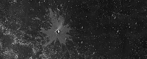 Young crater with bright ejecta, as seen by HiRISE under HiWish program The impact reached down to a layer that is light-toned. That light-toned material was then deposited on a dark surface.