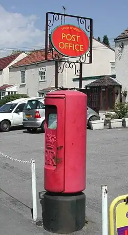 Unusual bracket carrying a Post Office "Lozenge" fitted to a Type K pillar at Easter Compton, S. Gloucs