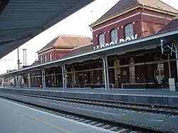 an empty train station with two platforms and two tracks