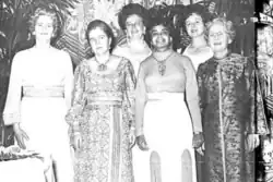 Six women in dresses, standing together for a group photograph, in 1972