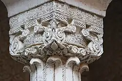 One of the intricately carved marble capitals above the columns in the courtyard