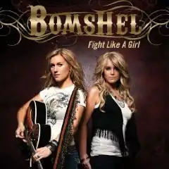 A photo of the two band members, one holding a guitar, stood in front of a dark brown wall, with the band's logo and album's name over their heads.