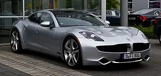 A front three-quarters view of a gray Fisker Karma sedan