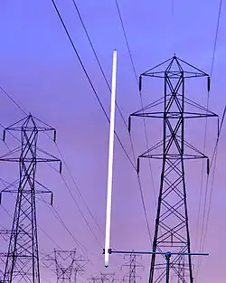 Capacitive coupling with high-voltage power lines can light a lamp continuously at low intensity.