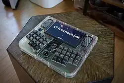 Framedeck, a Framework motherboard based cyberdeck with clear acrylic and brass influenced by TRS-80 Model 100