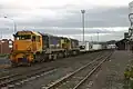 DFT 7295 and DC 4847 departing Dunedin with a freight train.