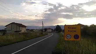 Sign hailing entrance on road into Kozjak