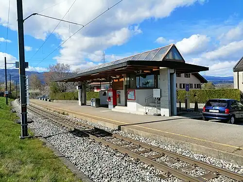 Glass roof shelter on a station platform next to a railway line