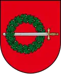 A coat of arms depicting a sword with a gold hilt and a silver blade penetrating a green wreath all on a red background
