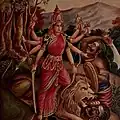Durga is depicted in the Hindu pantheon as a Goddess riding a lion and with many arms, each carrying a weapon to defeat Mahishasura or the buffalo demon