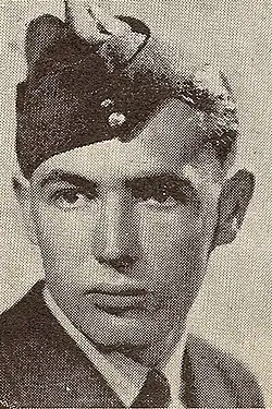 Black and white photograph, from the shoulders up, of a man wearing a uniform and a cap