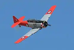 Grey and red aeroplane in the air