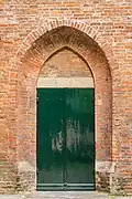 Side entrance in a masonry arch.