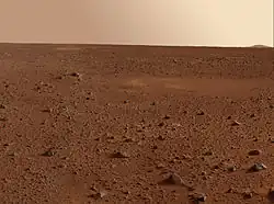 view of Martian desert showing rock field to the horizon