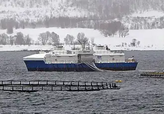 Fish farm Högtind in Norway with feeding barge