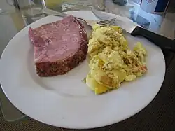 A thick-cut ham steak and scrambled eggs