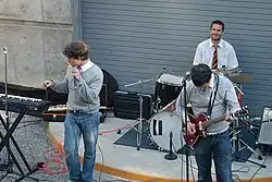 Photograph of a group playing instruments in an amphitheater.