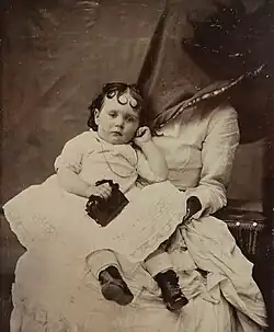 Mother only partly hidden in this portrait to comfort child