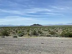 The hill and desert landscape used in the album cover, shot out a car window.