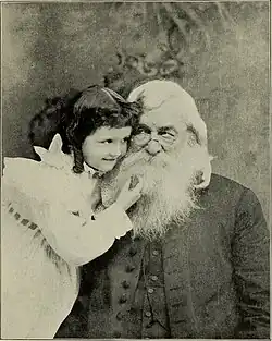 Small white girl and old white man with a beard, in an affectionate embrace.
