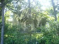 19th century home hidden behind trees