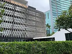 The IBM Building with a smooth white corridor leading to a white cube-shaped structure sticking out of its side.