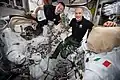 Morgan and ESA commander Luca Parmitano checking U.S. spacesuits and spacewalking tools