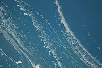 Fish Island (left) and Fisherman Shoal (to the right) on February 22, 2014 with ice stringers; north is oriented to the left. During February 2014, Lake Michigan's waters were lower at 175.95 meters above sea level. Photo taken during Expedition 38 of the International Space Station.
