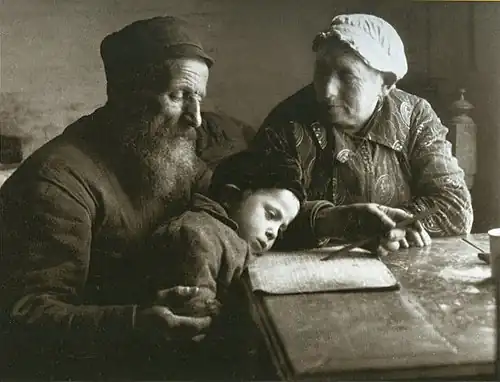 Polish Jewish grandparents in Biala Podlaska teach their grandson to read, 1920.