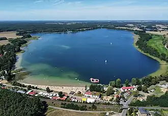A body of water surrounded by buildings and trees.