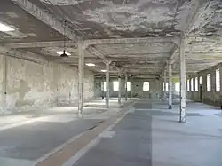 A large empty concrete hall with support pillars