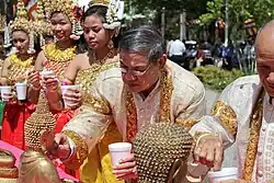 Elders cleanse statues of the Buddha with perfumed water in Cambodia