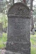 Tzedakah box on Jewish gravestone. Jewish cemetery in Otwock.