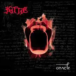 A flaming mason jar against a black background. The text "Kittie" in top left corner, and "Oracle" on bottom right corner
