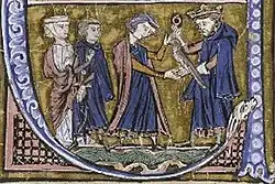 A bearded man wearing a crown gives a falcon to a younger man who is accompanied by a woman and a man.
