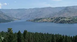 View of Lake Chelan with barren hills in background